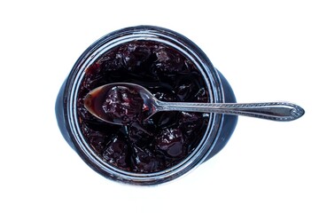 Top view sour cherry jam in glass jar, isolated on white background.
