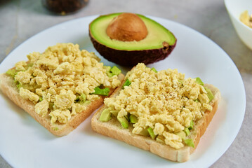 Toasts with avocado and egg on white plate, Healthy food and dieting concept, Organic product