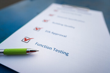 A pen is placed on the equipment checklist form with checking guideline follow the common industrial safety working procedure. Close-up and selective focus at the pen's nib.