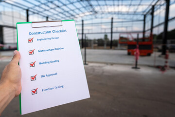 A project engineer is using construction safety checklist guideline form to checking the factory...