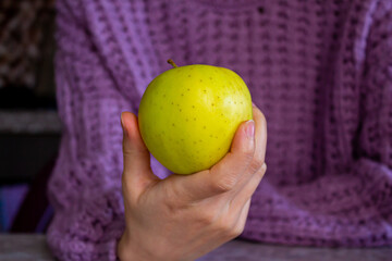 Closeup photo of woman holding yellow apple