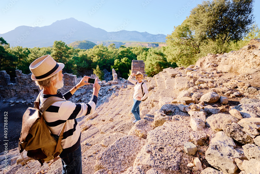 Wall mural travel and tourism. senior family couple taking photo together on ancient sightseeing.