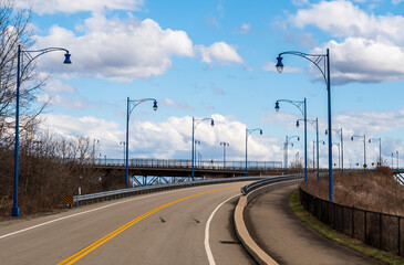 A streetlamp lined road leading to the Rankin Bridge in Rankin, Pennsylvania, USA on a sunny winter day