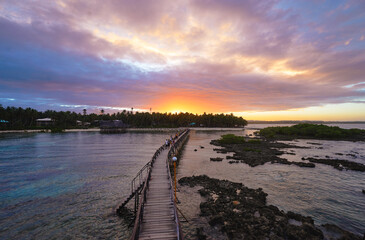 Beautiful landscape. Sunset on the seashore. Wooden bridge on Cloud Nine beach, Siargao Island Philippines.