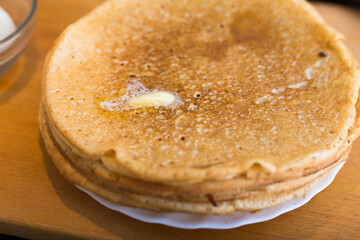 stack of appetizing flour pancakes in the kitchen during cooking