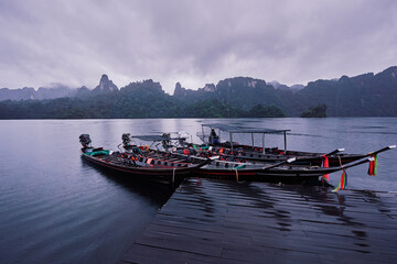 Traditional wooden boats on wharf in Cheow Lan Lake, Khao sok national park, Thailand.