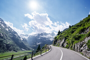 Asphalt road in Alp mountains. Road trip concept. Beautiful landscape. - Powered by Adobe
