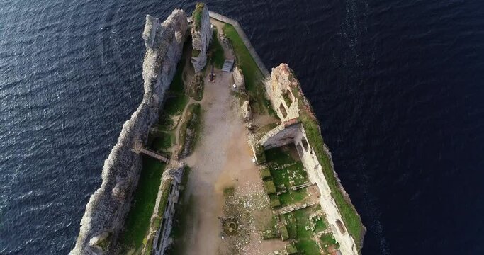 Aerial view of an old stone castle ruins in Koknese, Latvia. Located on a peninsula near the Daugava river and Perse river.