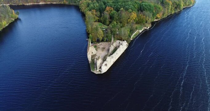 Aerial view of an old stone castle ruins in Koknese, Latvia. Located on a peninsula near the Daugava river and Perse river.