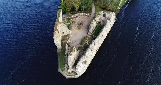 Aerial view of an old stone castle ruins in Koknese, Latvia. Located on a peninsula near the Daugava river and Perse river.