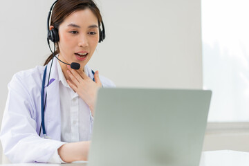 Asian therapist woman doctor is online visiting with a patient on the internet application. Her...