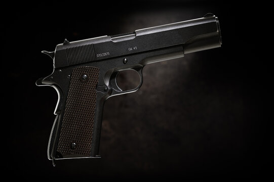 Colt 1911 pistol on the black background.
