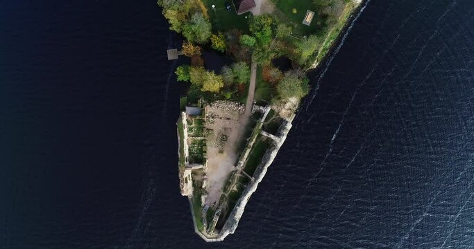 Aerial view of an old stone castle ruins in Koknese, Latvia. Located on a peninsula near the Daugava river and Perse river.