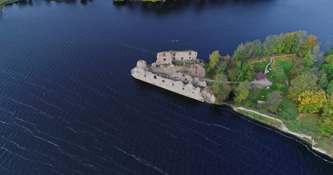 Aerial view of an old stone castle ruins in Koknese, Latvia. Located on a peninsula near the Daugava river and Perse river.