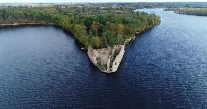 Aerial view of an old stone castle ruins in Koknese, Latvia. Located on a peninsula near the Daugava river and Perse river.