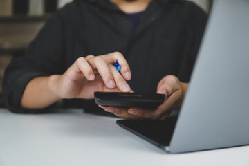 business people use calculator and notebook on desk, business people working on desk