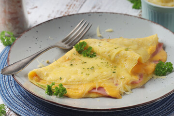 Omelette with ham and cheese on the plate