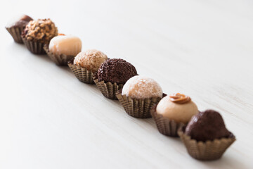 Brigadeiro candies diagonally aligned - close up - White background