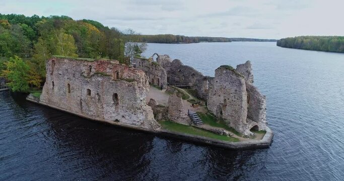 Aerial view of an old stone castle ruins in Koknese, Latvia. Located on a peninsula near the Daugava river and Perse river.