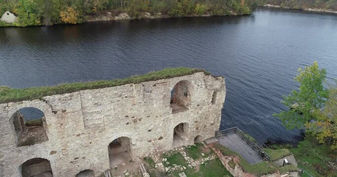 Aerial view of an old stone castle ruins in Koknese, Latvia. Located on a peninsula near the Daugava river and Perse river.