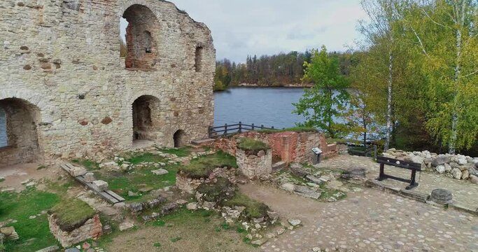 Aerial view of an old stone castle ruins in Koknese, Latvia. Located on a peninsula near the Daugava river and Perse river.