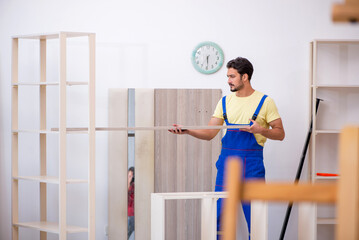 Fototapeta na wymiar Young male carpenter working at workshop
