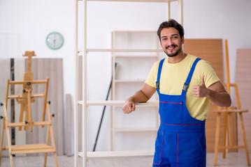 Young male carpenter working at home
