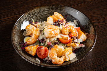 salad with shrimps on wooden background