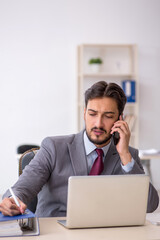 Young male employee working in the office