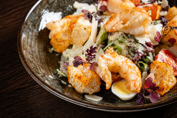 salad with shrimps on wooden background