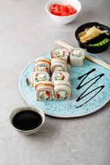 Sushi rolls and soy sauce on plate