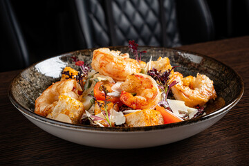 salad with shrimps on wooden background