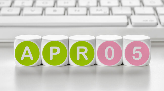 Letter dice in front of a keyboard - April 05