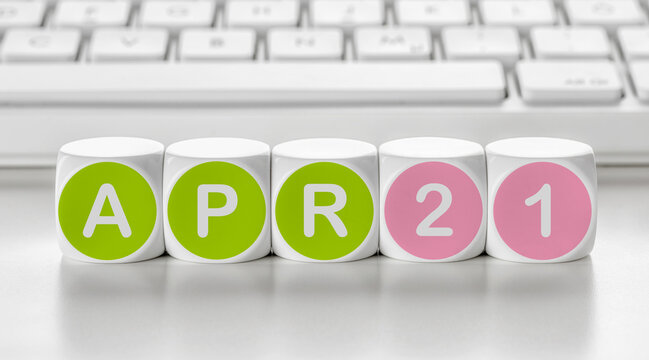 Letter dice in front of a keyboard - April 21