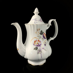 antique figured teapot with hand painting. retro tea set with floral pattern on black isolated background