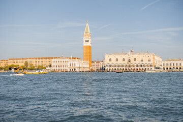 Fototapeta na wymiar Landscape view from the sea on Saint Mark's basilica and bell tower in Venice. Autumn sunny day. Concept of famous italian landmarks and tourist attraction
