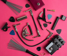 Music equipment on a hot pink background. Guitar accessories. 
