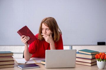Young female student preparing for exams in the classroom