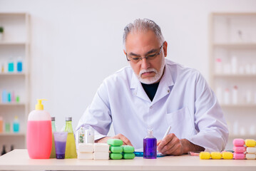 Old male chemist testing soap in the lab