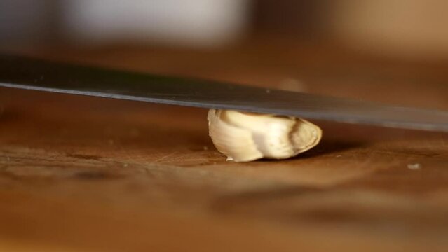 Crush garlic for cooking in the kitchen