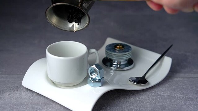 Hardware concept. Rotation wood screws pouring from turk into coffee cup on plate with hardware. 