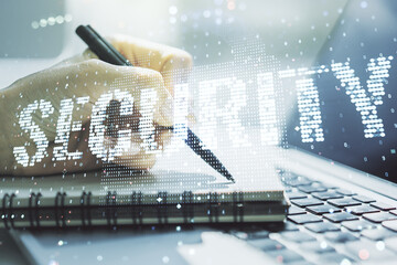 Cyber security creative concept with hand writing in notepad on background with laptop. Double exposure