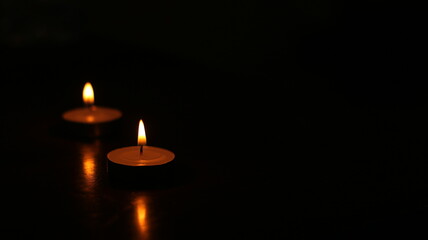 Two candle light burning in the dark place. For using in traditional activity and rite.