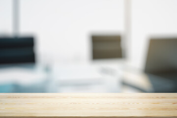 Empty wooden office table with light sunny workplace with computer on background, mockup