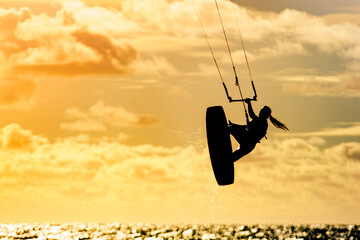 Kite surfer riding waves. Kiteboarding sport.