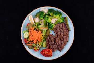 Delicious Steak With Vegetables On The Blue Plate