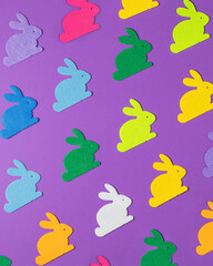 Pattern of colorful Easter bunnies on the purple background.