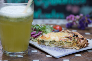 Pizza served with salad and lemonade 