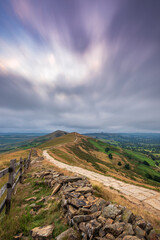 Mam Tor ridgeway, the Peak District, on a moody, cloudy summer's morning. Long exposure to show the movement in the clouds