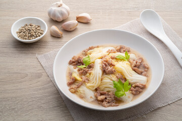 Stir-fried napa cabbage with minced pork with oyster sauce in white plate